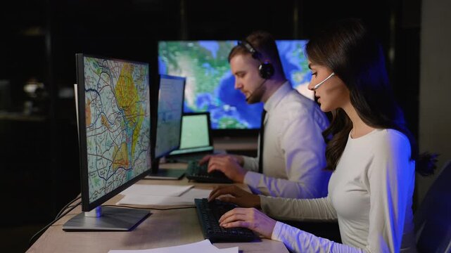 Logistics dispatchers monitoring global cargo delivery on computers