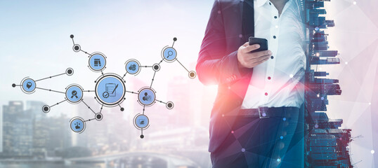A businessman in a suit is holding a smartphone, with a digital network overlay representing...