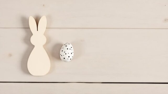 Minimal easter bunny decor with polka dot egg on wooden background