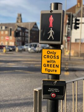 red sign on a pelican crossing with defocused urban background in boston lincs. uk