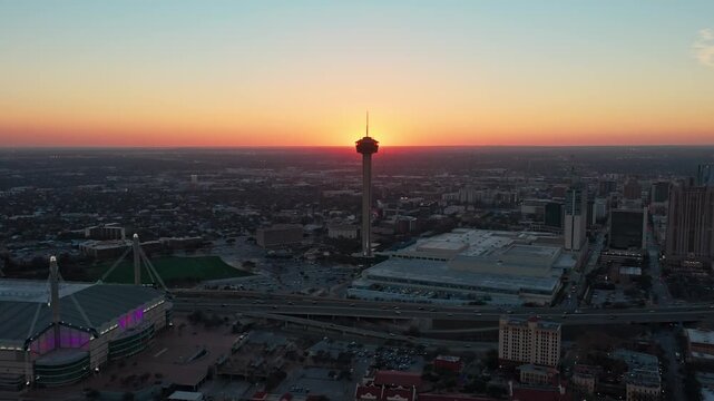 Aerial Approach Shot of Tower of the Americas Eclipsing the Sun Over Downtown San Antonio During Colorful Sunset