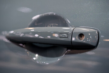 Close up of car door handle with keyhole