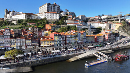 Obraz premium Ribeira Pier In Porto Portugal. Bird Eye View Of A Amazing Coastal Beach In The Summer Holiday. Business Sky Background Downtown Cityscape. Backgrounds Panorama. Porto Portugal.