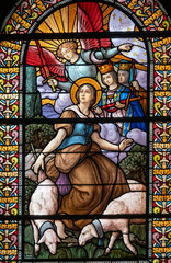 Stained glass (1916) of Saint Joan of Arc receiving divine voices.