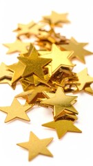 Obraz premium Shiny, scattered golden star confetti on a white surface