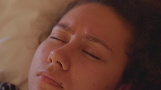 Drowsy guest at dawn. Late night sleeper waking up slowly. Early morning scene with sleepy guest and gentle lighting. Intimate portrait of weary guest emerging from sleep at dawn with soft light