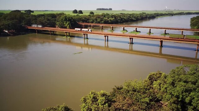 Aerial drone view of bridge over Rio Pardo with trucks and cars traffic in Brazil