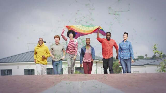 Group of six adults running downhill toward camera after raising rainbow flag, celebrating pride