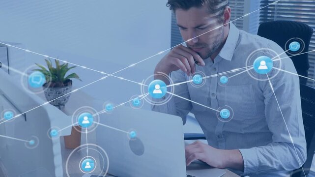 Man leaning and typing on laptop in tech office starting network nodes and links for analysis