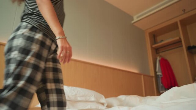 Caucasian guest relaxing. Calm guest resting barefoot on bedding. Relaxed individual barefoot on bed with peaceful surroundings. Serene scene of person lying barefoot on bed in modern room