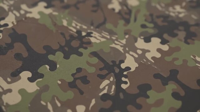 Classic military camouflage fabric pattern in green brown black hues