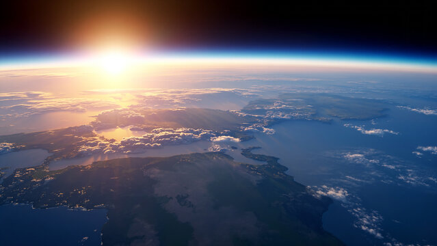 The sun rises over the curvature of the earth as seen from orbit