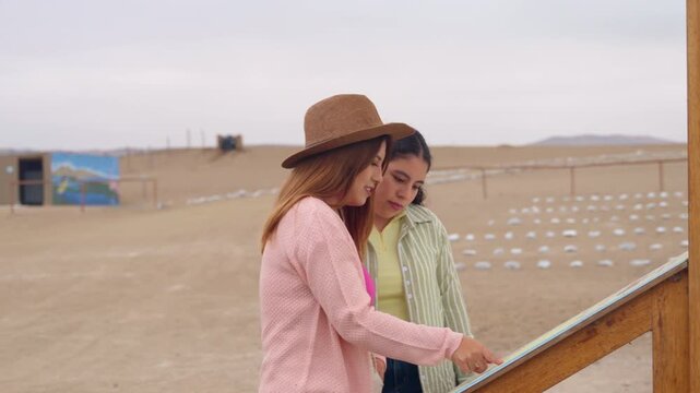 Female tourists looking at a map of archaeological ruins in peru