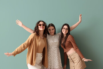Happy teenage girls on turquoise background