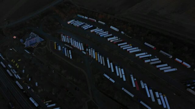 Twilight Cold Chain Trailer Staging Yard With Refrigerated Units Lined, Temperature Teams Preparing Shipments, Urgent Medical Cargo Handling, Monitoring Sensors And Protocols.