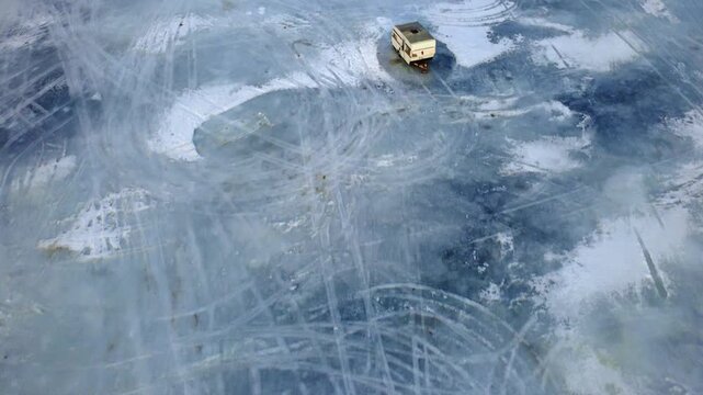 Ice fishing shacks on lake flyover