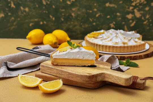 Spatula with piece of tasty lemon pie on beige grunge table, closeup