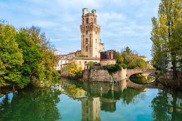 Fototapeta premium Specola museum with water reflections in Padua, Veneto, Italy; museum of the astronomical observatory of Padua on river Bacchiglione waterfront