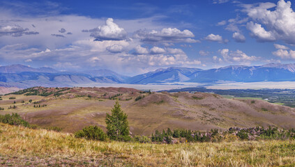 A spacious mountain valley, picturesque sky with clouds