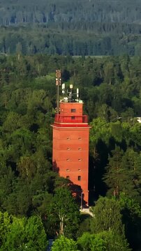 Vertical drone shot orbiting the water tower in Tammisaari, summer eve in Finland