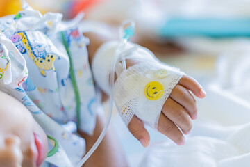 Kid patients have IV tube child's hand Children's patient in the hospital with saline intravenous (iv) was punctured with an IV needle by a doctor