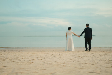 Romantic Soft Focus Wedding Couple Holding Hands on a Tropical Beach