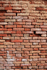 An old weathered, clay brick wall with visible texture, imperfections, weathering etc