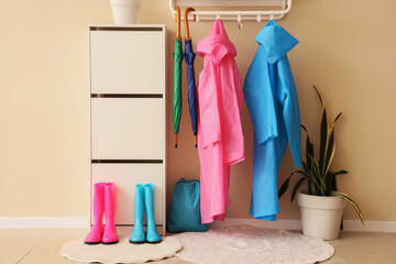 Interior of hallway with raincoats, gumboots and drawers