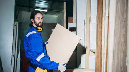 Professional Woodworker Measuring, Cutting and Installing Timber in Factory. Carpentry and Wood Manufacturing Process in Industrial Workshop