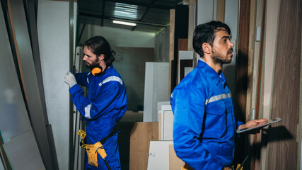 Professional Woodworker Measuring, Cutting and Installing Timber in Factory. Carpentry and Wood Manufacturing Process in Industrial Workshop