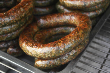 Grilled sausages on barbeque grill close up