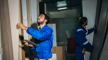 Professional Woodworker Measuring, Cutting and Installing Timber in Factory. Carpentry and Wood Manufacturing Process in Industrial Workshop