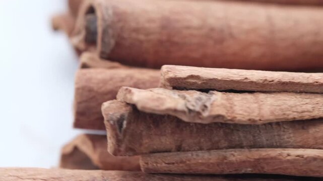 Close up footage of cinnamon sticks stacked together revealing their texture and natural form