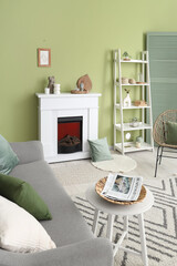 Fototapeta premium Interior of living room with electric fireplace and shelf unit