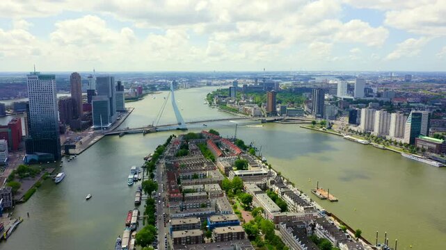 Rotterdam, Netherlands. Norderayland Island ( North Island ) and Erasmus Bridge ( Erasmusbrug ) over the Nieuwe Maas River. Drone footage