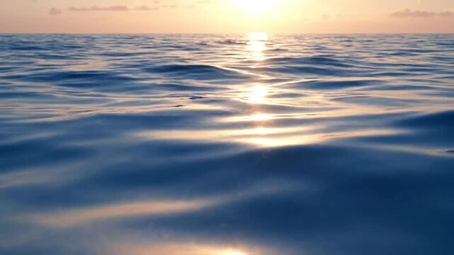Sunlight reflecting on calm ocean waves at sunset video