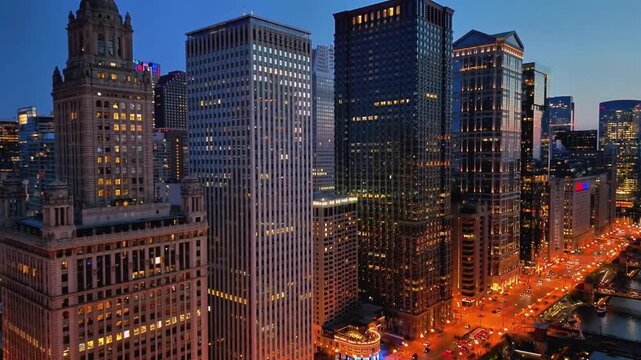 A cinematic drone shot of Chicago from over Lake Michigan at night, where the skyline glows with city lights reflecting across the dark water, creating a bold and dramatic aerial view.