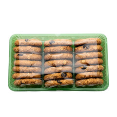 Crunchy oatmeal cookies neatly stacked in green plastic tray, isolated on white or transparent background, PNG Format.