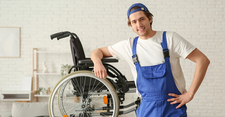 Male worker repairing wheelchair in room
