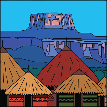 Traditional african village huts with large plateau mountain in background