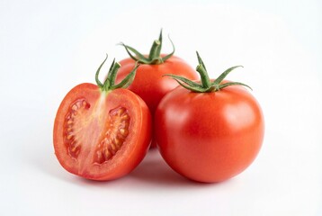 Three fresh red tomatoes, two whole and one halved, with green stems on a white background