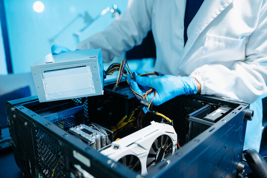 Professional technician repairing hard drive for data recovery in modern technology lab. Digital storage, cybersecurity, hardware repair and data protection concept.
