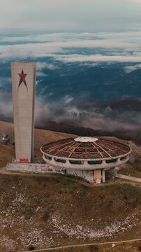 A vertical drone shot of an abandoned soviet era monument. Captured with the drone zoom lens in 4k- vertical mode