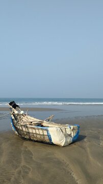 Close-up of Traditional Rustic Wooden Fishing Boat on Sandy Beach Shore at cox's bazar
