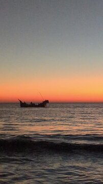 Tranquil Ocean Sunset with Silhouette of Traditional Fishing Boat - 4K Cinematic Seascape at cox's bazar