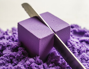 Perfect Cube of Purple Kinetic Sand Being Sliced with Precision Knife