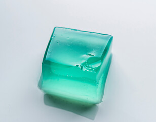 Translucent Turquoise Jelly Cube Vibrating on White Surface High Speed