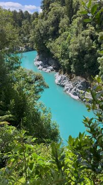 Turquoise water at Hokitika Gorge surrounded by native forest, West Coast, South Island, New Zealand. Scenic river canyon landscape.
