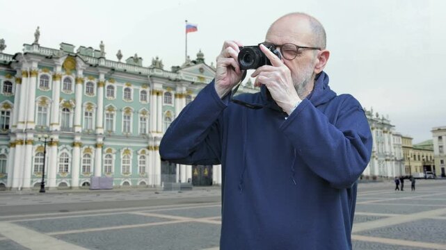 Senior man photographing Hermitage Museum in Moscow Russia travel art