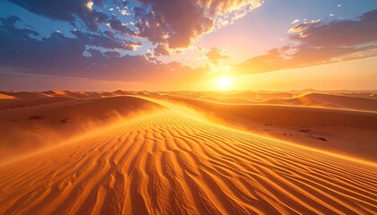 Naklejka premium Sunset over a vast desert, rippled sand, and a vibrant sky